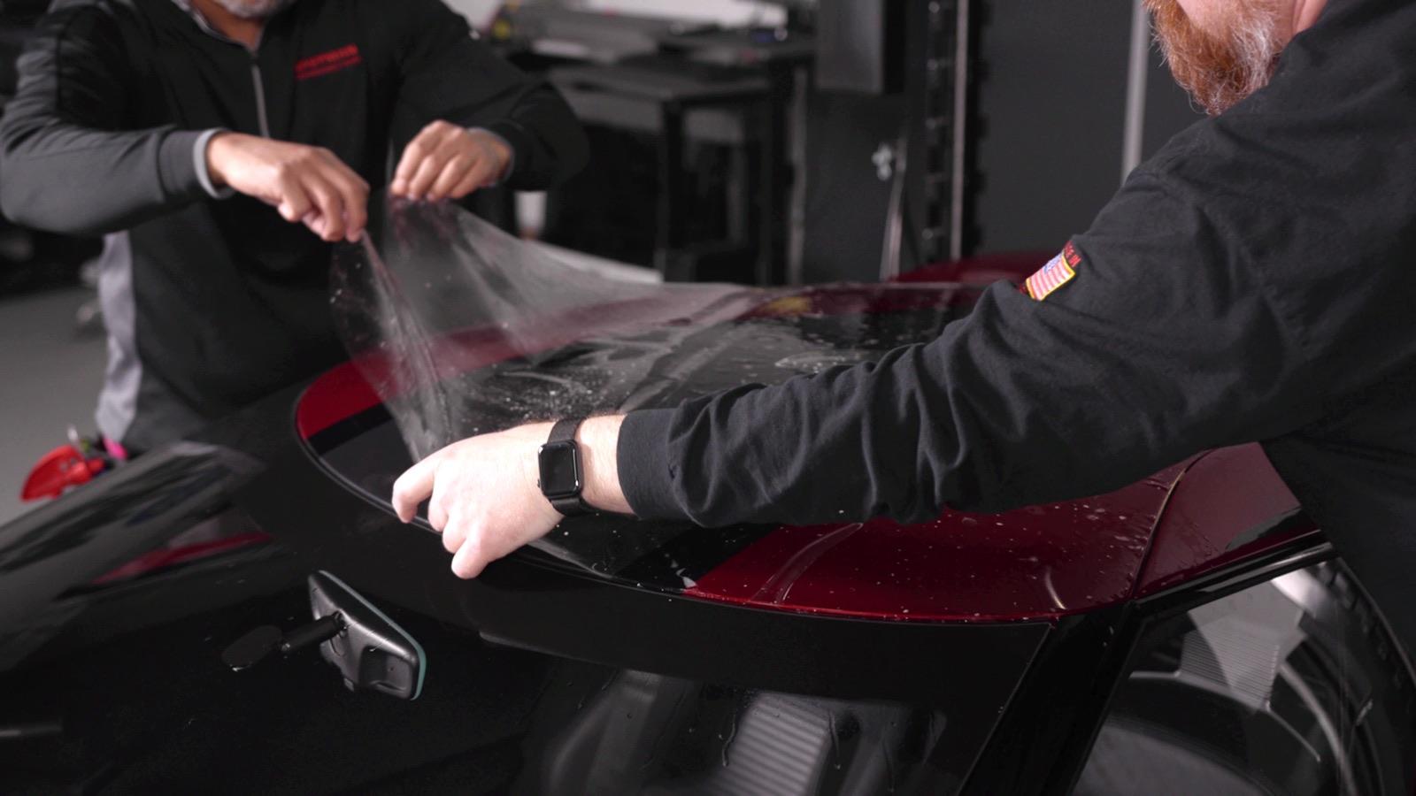 Installers applying LLumar paint protection film to a Ford GT