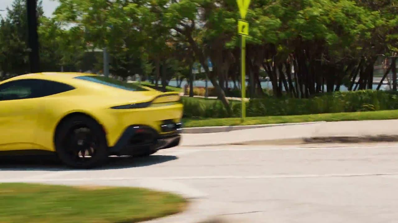 Yellow sports car on a tree-lined road