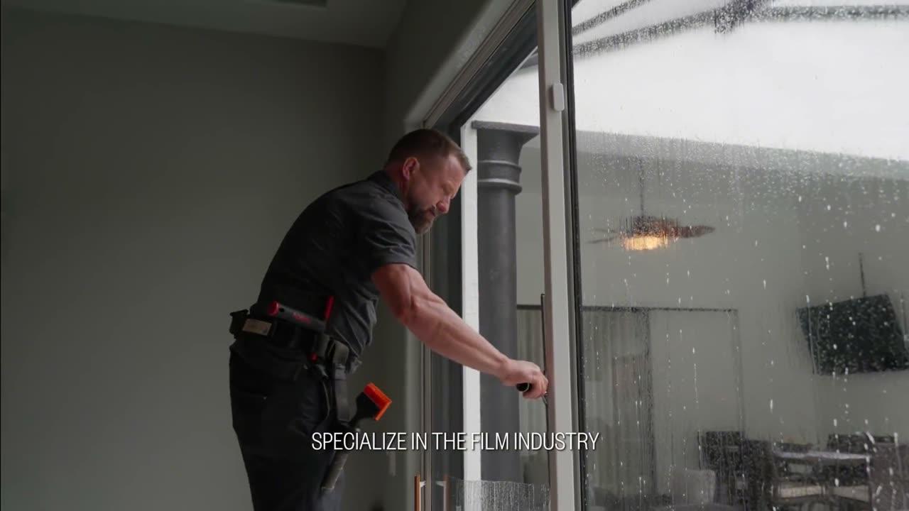 Installer working on a sunlit patio door — heat rejection video poster