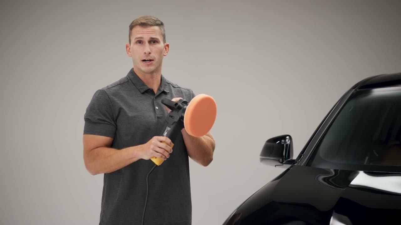 Applicator pad held beside a black car — video poster